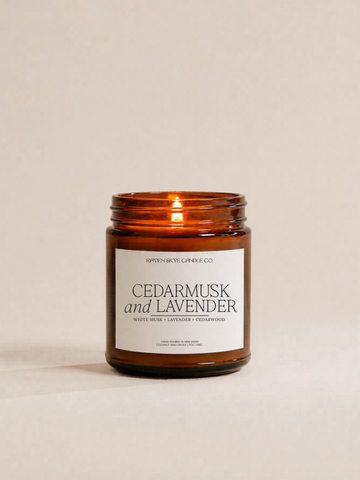 Candle with a label reading 'Cedarmusk and Lavender' on a beige background