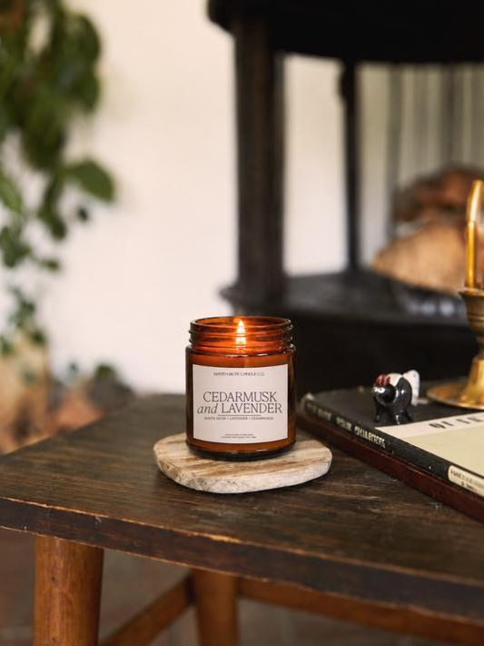 Candle with a label on a wooden table in a cozy setting
