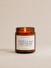 Candle with a label reading 'Vanilla and Deep Musk' on a beige background